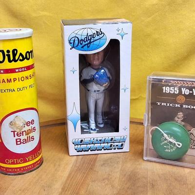 Yoshinobu Yamamoto bobblehead, vintage tennis balls, and vintage yo-yo