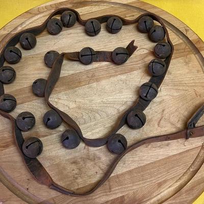 Antique metal sleigh bells on leather straps for horse or sleigh