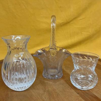 A set of three vintage crystal decorative pieces, including a basket and two small vases
