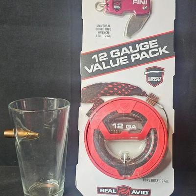 Bullet hole novelty drinking glass and Real Avid 12-gauge cleaning kit