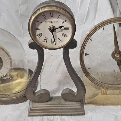 Group of vintage mid-century desk and mantel clocks offered for parts or repair.