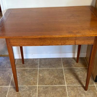 Wooden Table appears solid wood with tapered legs