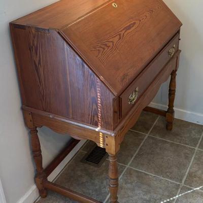 Vintage wooden drop-front secretary desk with cubbies, likely early-mid 20th century