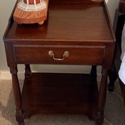 Wood nightstand, appears vintage with single drawer, lower shelf, and brass bail pull.