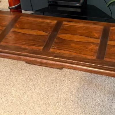 Wooden paneled tabletop, appears solid wood, likely coffee table or bench top.