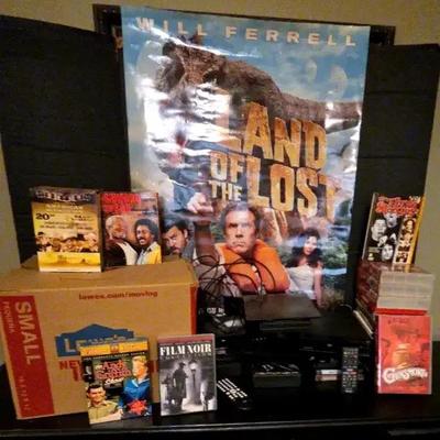 VHS & DVD Media Collection with Sony and Magnavox DVD Players and Land of the Lost Poster