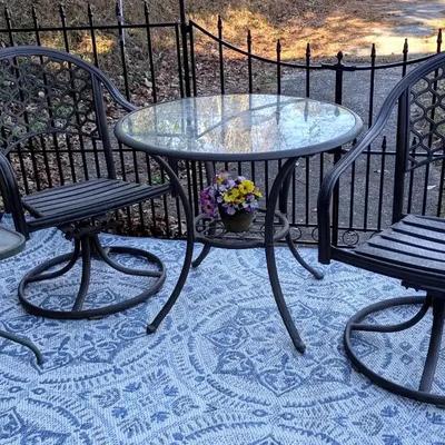 Metal Outdoor Bistro Table with Two Swivel Chairs & Area Rugs