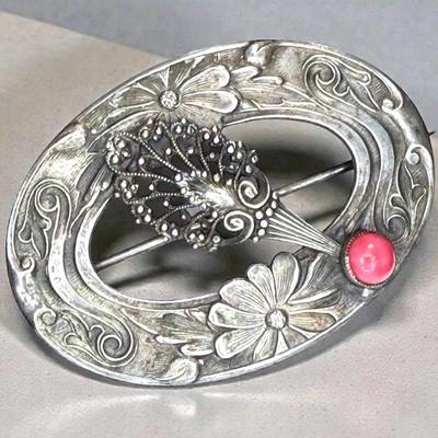 Silver brooch with blooming flower motif