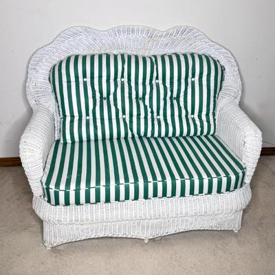 White Wicker Settee With Green and White Striped Cushion