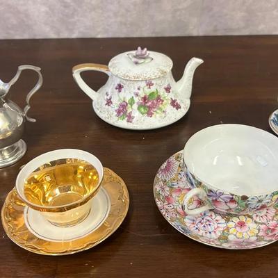 Assortment Of Tea Cups, Saucers, & Pitchers 