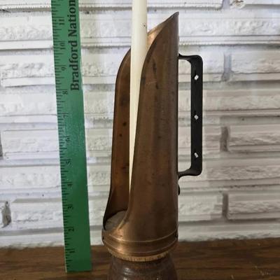 Antique colonial-style copper reflector candle holder with a wood base and iron handle. 