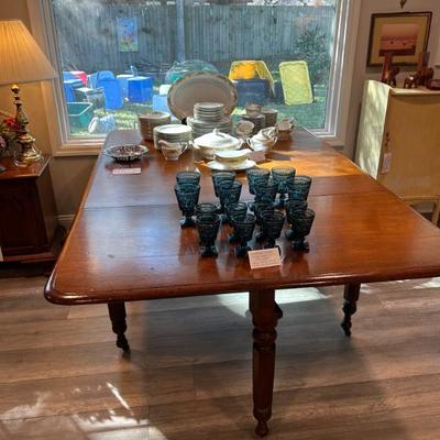 Gorgeous antique solid walnut drop leaf table on casters. 