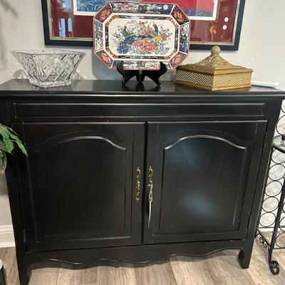 Solid black 2-door cabinet. 