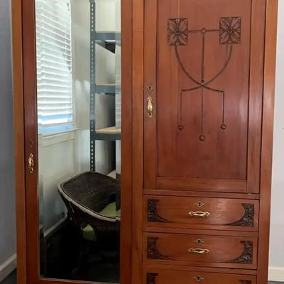 Ornate Wooden Armoire with Mirror Door, Drawers, and Storage Compartments