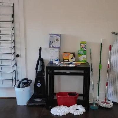 Household Cleaning Supplies Group with Riccar Vacuum, Ironing Board, and Storage Rack
