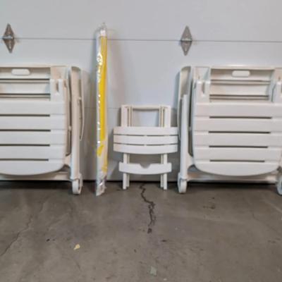 White Plastic Outdoor Lounge Chairs, Side Table, and Patio Umbrella