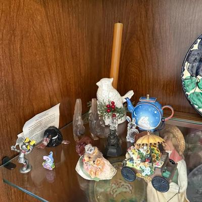 Collection of figurines, including a white bird, clear and dark rabbit figures, a small hous