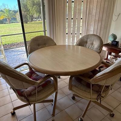 Mid-Century Style Round Dining Table with Four Rolling Upholstered Chairs