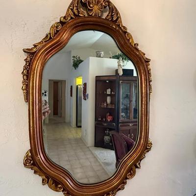 Ornate Gilt Framed Wall Mirror with Rococo-Style Carved Details and Scalloped Oval Shape**