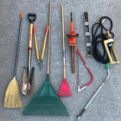 
Yard Tool Lot - Rakes, Stanley Level, Black & Decker 16" Trimmer, Hose, Shovel, And More