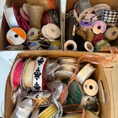 Three bankers boxes full of decorative ribbon
