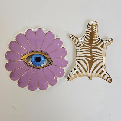 Lot #7 - Jonathan Adler trinket trays: a lavender-accented Muse Sun Trinket Tray and a Zebra hide-shaped tray. 