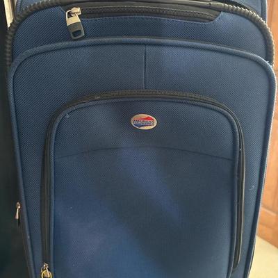 Lot 671:  American Tourister Blue Soft-Side Rolling Carry-On Suitcase with Front Pocke