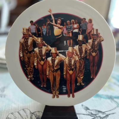 311B: Avon Images of Hollywood “A Chorus Line” Decorative Collector Plate w/ Stand  This decorative 