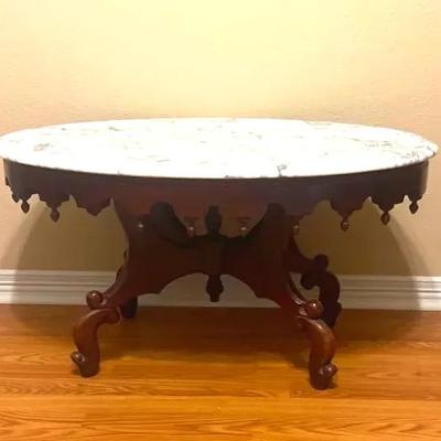 Victorian-style oval coffee table with a white marble top