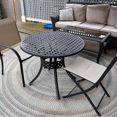 Cast Aluminum Round Table And Two Aluminum Framed Chairs