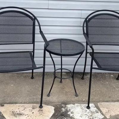 Pair of black metal patio chairs and table 