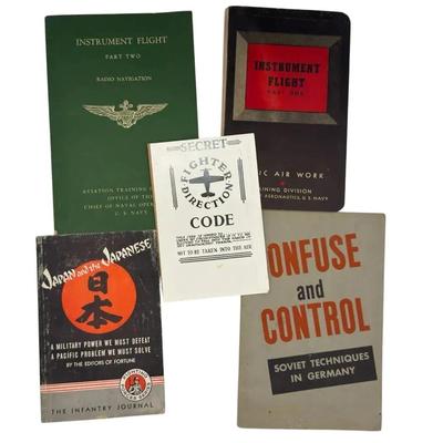 Collection of vintage U.S. Navy and military-related booklets and manuals from the World War II era.