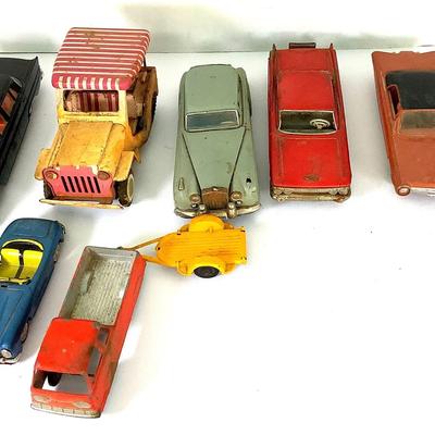 Nine Piece Set Of Vintage Plastic And Tin Toy Cars In “Play Worn” Condition 