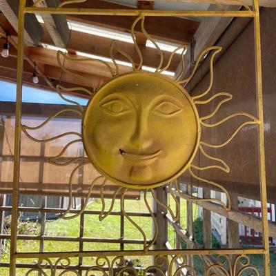 Sun Metal Art Wall Hanging With An Assortment Of Pots And Plastic Watering Jug