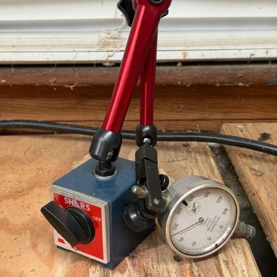 Shars magnetic base stand with an articulated arm, holding a dial indicator gauge