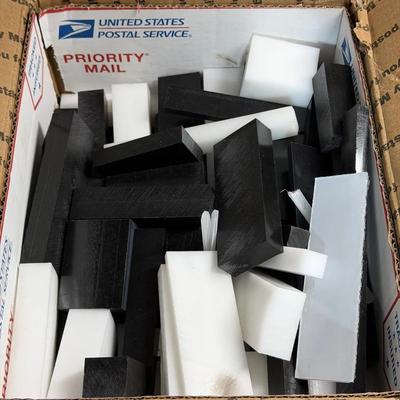 box of assorted black and white acetal (polyoxymethylene or POM) plastic stock