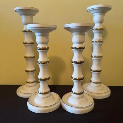 A Set Of Four Distressed Antique Candle Holders