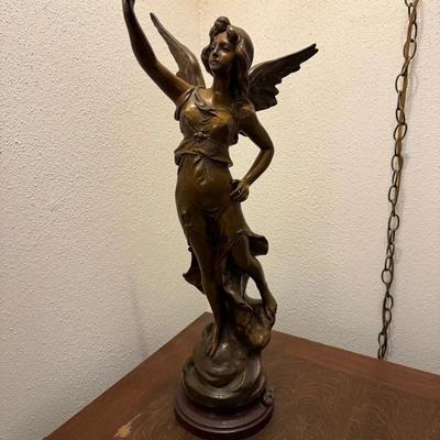 bronze or patinated metal sculpture of a winged female figure