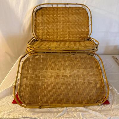9-This is a set of vintage woven bamboo and rattan serving trays, often referred to as "TV trays"