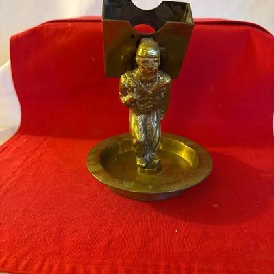 “Antique brass figural miner match holder with ash catch base”