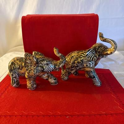 Pair of Decorative Porcelain Elephant Figurines with Animal Print Design”