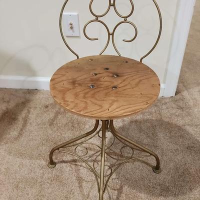 Small Rotating Wooden Chair with a Round Seat and Metal Legs and Back