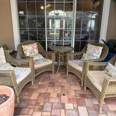 Four Plastic Wicker Chairs With Cushions And Table
