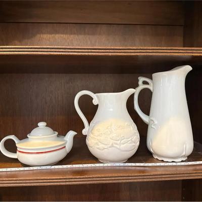 Set a three white varied theme pitchers/teapot