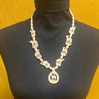 Vintage carved bone necklace with camel figures and oval beads