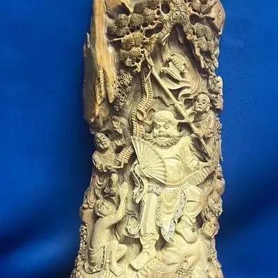 An antique Chinese intricately carved petrified wood sculpture depicting a mountain scene
