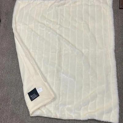 A cream-colored Dennis Basso Home faux fur throw blanket, 4’ x 4.5’ approximately 