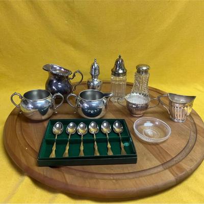 A collection of pewter and silver-plated tea and dining accessories with spoons