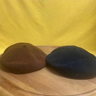 Two vintage wool berets, one brown and one black