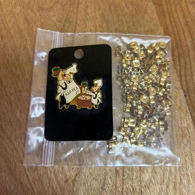 Andersen’s Pea Soup lapel pin and bag of earring backings 